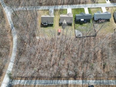 Discover a beautiful level private wooded lot on a paved road in on Lake Tansi Village Country Club in Tennessee - for sale on GolfHomes.com, golf home, golf lot