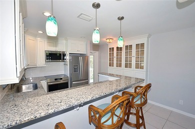 Remodeled end unit w/ serene golf/lake views, tons of natural on The American Golf Club in Florida - for sale on GolfHomes.com, golf home, golf lot