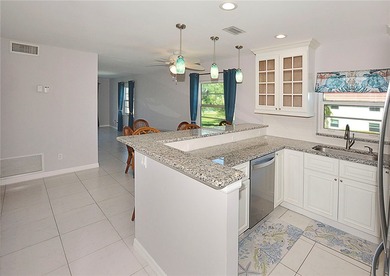 Remodeled end unit w/ serene golf/lake views, tons of natural on The American Golf Club in Florida - for sale on GolfHomes.com, golf home, golf lot