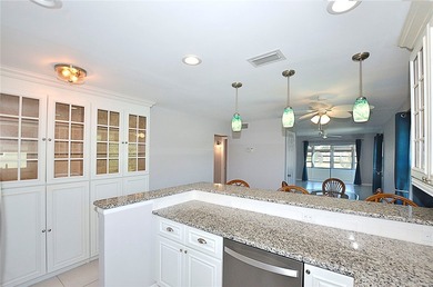 Remodeled end unit w/ serene golf/lake views, tons of natural on The American Golf Club in Florida - for sale on GolfHomes.com, golf home, golf lot