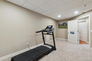 Step into this stunning 4-bedroom brick colonial located in the on Oakhurst Golf and Country Club in Michigan - for sale on GolfHomes.com, golf home, golf lot