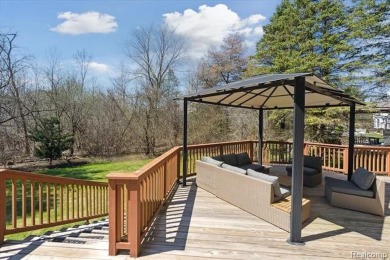 Step into this stunning 4-bedroom brick colonial located in the on Oakhurst Golf and Country Club in Michigan - for sale on GolfHomes.com, golf home, golf lot
