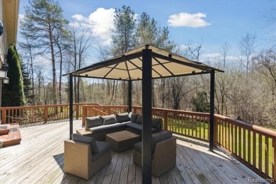 Step into this stunning 4-bedroom brick colonial located in the on Oakhurst Golf and Country Club in Michigan - for sale on GolfHomes.com, golf home, golf lot