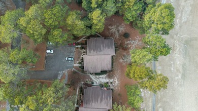 Nestled beneath a canopy of mature longleaf pines, this charming on Hyland Golf Club in North Carolina - for sale on GolfHomes.com, golf home, golf lot