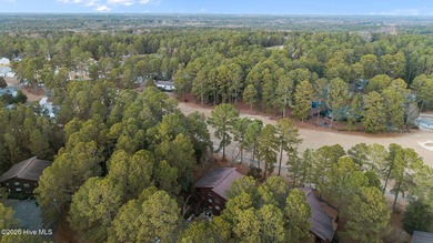Nestled beneath a canopy of mature longleaf pines, this charming on Hyland Golf Club in North Carolina - for sale on GolfHomes.com, golf home, golf lot