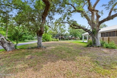 Corner lot adorned with magnificent live oaks, nestled in the on The Bridges Golf Club At Hollywood Casino in Mississippi - for sale on GolfHomes.com, golf home, golf lot