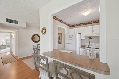 This one is a gem! With stylish finishes, wood flooring, cozy on Palm Aire Country Club of Sarasota in Florida - for sale on GolfHomes.com, golf home, golf lot