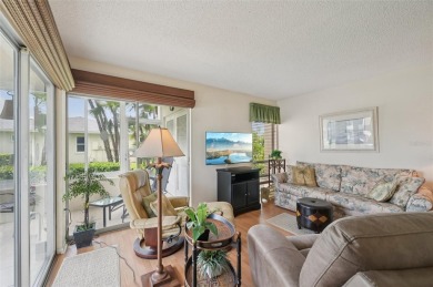 This one is a gem! With stylish finishes, wood flooring, cozy on Palm Aire Country Club of Sarasota in Florida - for sale on GolfHomes.com, golf home, golf lot