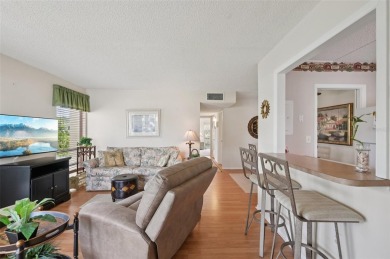 This one is a gem! With stylish finishes, wood flooring, cozy on Palm Aire Country Club of Sarasota in Florida - for sale on GolfHomes.com, golf home, golf lot