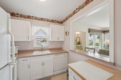 This one is a gem! With stylish finishes, wood flooring, cozy on Palm Aire Country Club of Sarasota in Florida - for sale on GolfHomes.com, golf home, golf lot