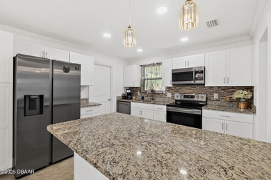 Discover the perfect blend of modern style and relaxed Florida on Daytona Beach Golf Club in Florida - for sale on GolfHomes.com, golf home, golf lot