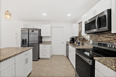 Discover the perfect blend of modern style and relaxed Florida on Daytona Beach Golf Club in Florida - for sale on GolfHomes.com, golf home, golf lot