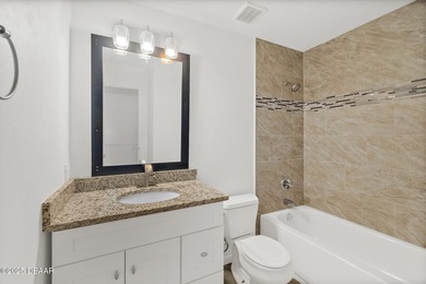 Discover the perfect blend of modern style and relaxed Florida on Daytona Beach Golf Club in Florida - for sale on GolfHomes.com, golf home, golf lot