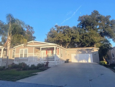 This open floor plan starts with a covered country rocking chair on Water Oak Country Club Estates in Florida - for sale on GolfHomes.com, golf home, golf lot