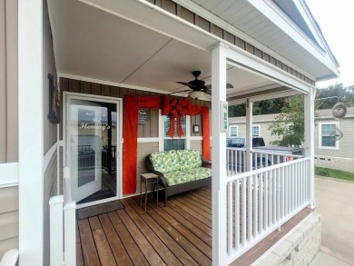 This open floor plan starts with a covered country rocking chair on Water Oak Country Club Estates in Florida - for sale on GolfHomes.com, golf home, golf lot