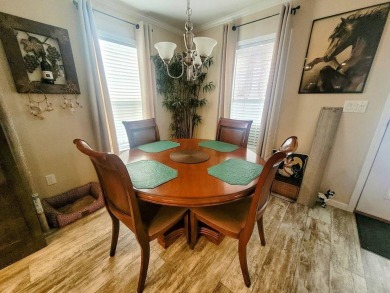 This open floor plan starts with a covered country rocking chair on Water Oak Country Club Estates in Florida - for sale on GolfHomes.com, golf home, golf lot