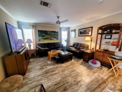 This open floor plan starts with a covered country rocking chair on Water Oak Country Club Estates in Florida - for sale on GolfHomes.com, golf home, golf lot