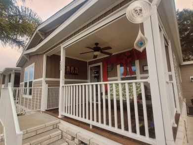 This open floor plan starts with a covered country rocking chair on Water Oak Country Club Estates in Florida - for sale on GolfHomes.com, golf home, golf lot