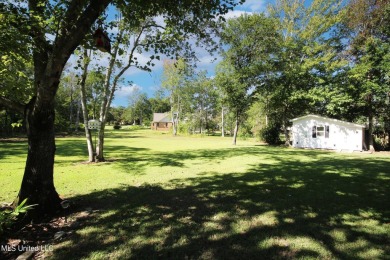 Discover this exquisite 4-bedroom home tucked away in on Diamondhead Country Club in Mississippi - for sale on GolfHomes.com, golf home, golf lot