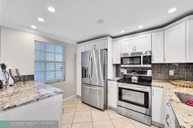 This fully remodeled unit features an open kitchen with white on Palm-Aire Country Club and Resort - Palms in Florida - for sale on GolfHomes.com, golf home, golf lot