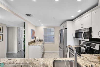 This fully remodeled unit features an open kitchen with white on Palm-Aire Country Club and Resort - Palms in Florida - for sale on GolfHomes.com, golf home, golf lot