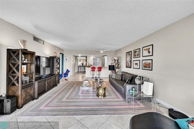 This fully remodeled unit features an open kitchen with white on Palm-Aire Country Club and Resort - Palms in Florida - for sale on GolfHomes.com, golf home, golf lot