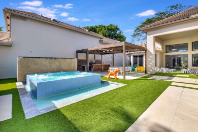Experience luxury living at its finest in this elegant & on Broken Sound Golf and Club  in Florida - for sale on GolfHomes.com, golf home, golf lot