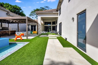 Experience luxury living at its finest in this elegant & on Broken Sound Golf and Club  in Florida - for sale on GolfHomes.com, golf home, golf lot