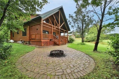 Experience the charm of this stunning log home on Northwood on Hardwoods Golf Club At Mille Lacs in Minnesota - for sale on GolfHomes.com, golf home, golf lot