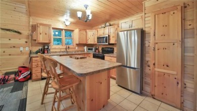 Experience the charm of this stunning log home on Northwood on Hardwoods Golf Club At Mille Lacs in Minnesota - for sale on GolfHomes.com, golf home, golf lot