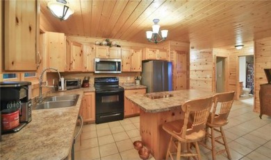 Experience the charm of this stunning log home on Northwood on Hardwoods Golf Club At Mille Lacs in Minnesota - for sale on GolfHomes.com, golf home, golf lot