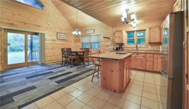 Experience the charm of this stunning log home on Northwood on Hardwoods Golf Club At Mille Lacs in Minnesota - for sale on GolfHomes.com, golf home, golf lot