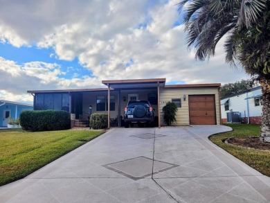 This manufactured home has a carport and a golf cart garage with on Orange Blossom Hills Golf and Country Club in Florida - for sale on GolfHomes.com, golf home, golf lot