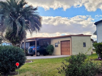 This manufactured home has a carport and a golf cart garage with on Orange Blossom Hills Golf and Country Club in Florida - for sale on GolfHomes.com, golf home, golf lot