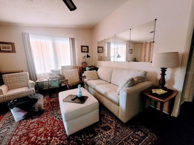 This manufactured home has a carport and a golf cart garage with on Orange Blossom Hills Golf and Country Club in Florida - for sale on GolfHomes.com, golf home, golf lot