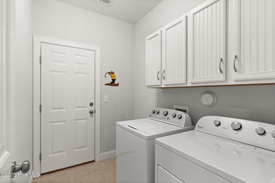 The all-brick former model home in the Regency Lakes section of on Members Club At St. James Plantation in North Carolina - for sale on GolfHomes.com, golf home, golf lot