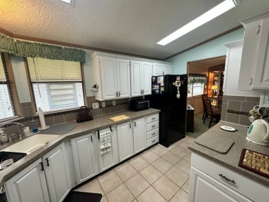 Beautiful stucco home on the exterior perimeter.  Updated on Del Tura Golf and Country Club in Florida - for sale on GolfHomes.com, golf home, golf lot