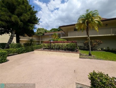 This beautifully renovated 3-bedroom, 2-bathroom corner unit at on Woodmont Country Club in Florida - for sale on GolfHomes.com, golf home, golf lot