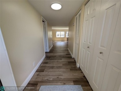 This beautifully renovated 3-bedroom, 2-bathroom corner unit at on Woodmont Country Club in Florida - for sale on GolfHomes.com, golf home, golf lot