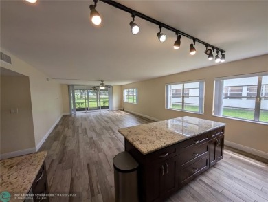This beautifully renovated 3-bedroom, 2-bathroom corner unit at on Woodmont Country Club in Florida - for sale on GolfHomes.com, golf home, golf lot