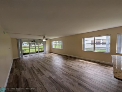 This beautifully renovated 3-bedroom, 2-bathroom corner unit at on Woodmont Country Club in Florida - for sale on GolfHomes.com, golf home, golf lot