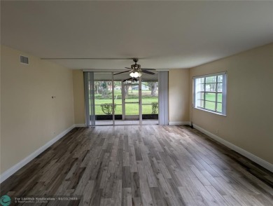This beautifully renovated 3-bedroom, 2-bathroom corner unit at on Woodmont Country Club in Florida - for sale on GolfHomes.com, golf home, golf lot