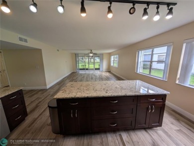 This beautifully renovated 3-bedroom, 2-bathroom corner unit at on Woodmont Country Club in Florida - for sale on GolfHomes.com, golf home, golf lot