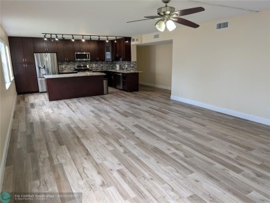 This beautifully renovated 3-bedroom, 2-bathroom corner unit at on Woodmont Country Club in Florida - for sale on GolfHomes.com, golf home, golf lot