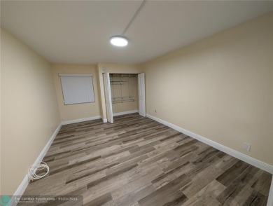 This beautifully renovated 3-bedroom, 2-bathroom corner unit at on Woodmont Country Club in Florida - for sale on GolfHomes.com, golf home, golf lot