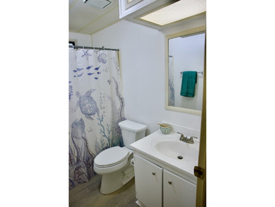 This lovely, 2/2 manufactured home on leased land in Lake on Pine Lakes Country Club in Florida - for sale on GolfHomes.com, golf home, golf lot