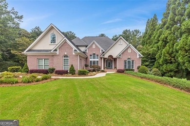 This exquisite four-sided blush brick estate is the epitome of on Royal Lakes Golf and Country Club in Georgia - for sale on GolfHomes.com, golf home, golf lot