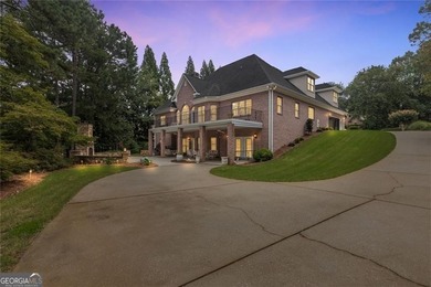 This exquisite four-sided blush brick estate is the epitome of on Royal Lakes Golf and Country Club in Georgia - for sale on GolfHomes.com, golf home, golf lot