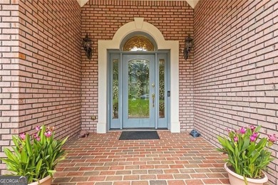 This exquisite four-sided blush brick estate is the epitome of on Royal Lakes Golf and Country Club in Georgia - for sale on GolfHomes.com, golf home, golf lot