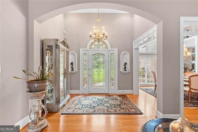 This exquisite four-sided blush brick estate is the epitome of on Royal Lakes Golf and Country Club in Georgia - for sale on GolfHomes.com, golf home, golf lot